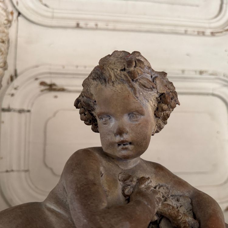 Terracotta statue representing Bacchus as a child on a barrel