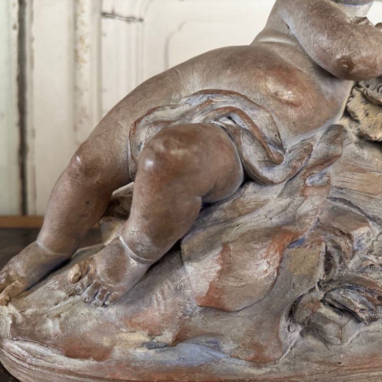 Terracotta statue representing Bacchus as a child on a barrel