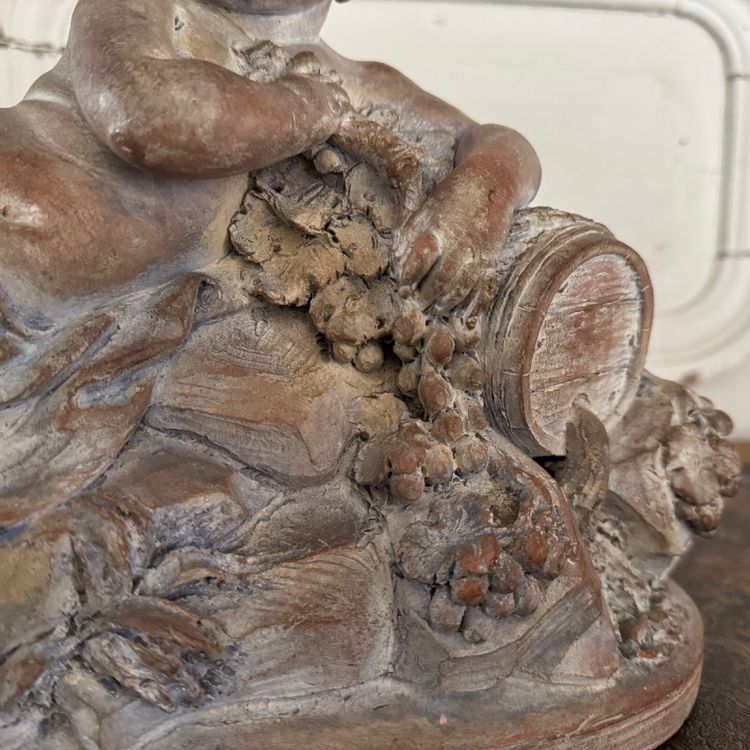 Terracotta statue representing Bacchus as a child on a barrel