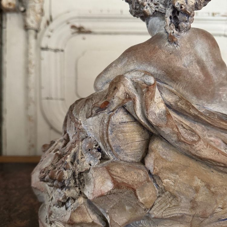 Terracotta statue representing Bacchus as a child on a barrel