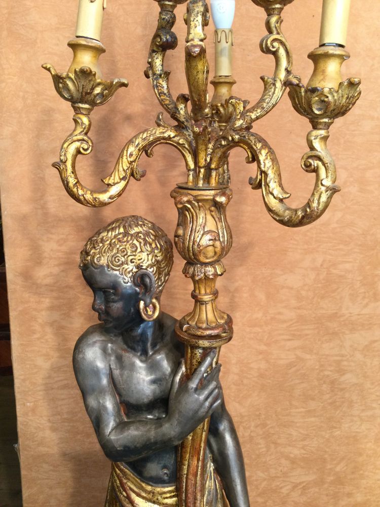 A large "Nubian" floor lamp in the Italian Baroque style, in painted and gilded wood.