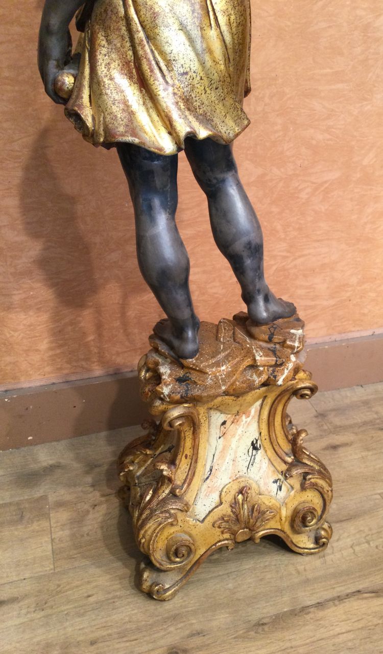 A large "Nubian" floor lamp in the Italian Baroque style, in painted and gilded wood.