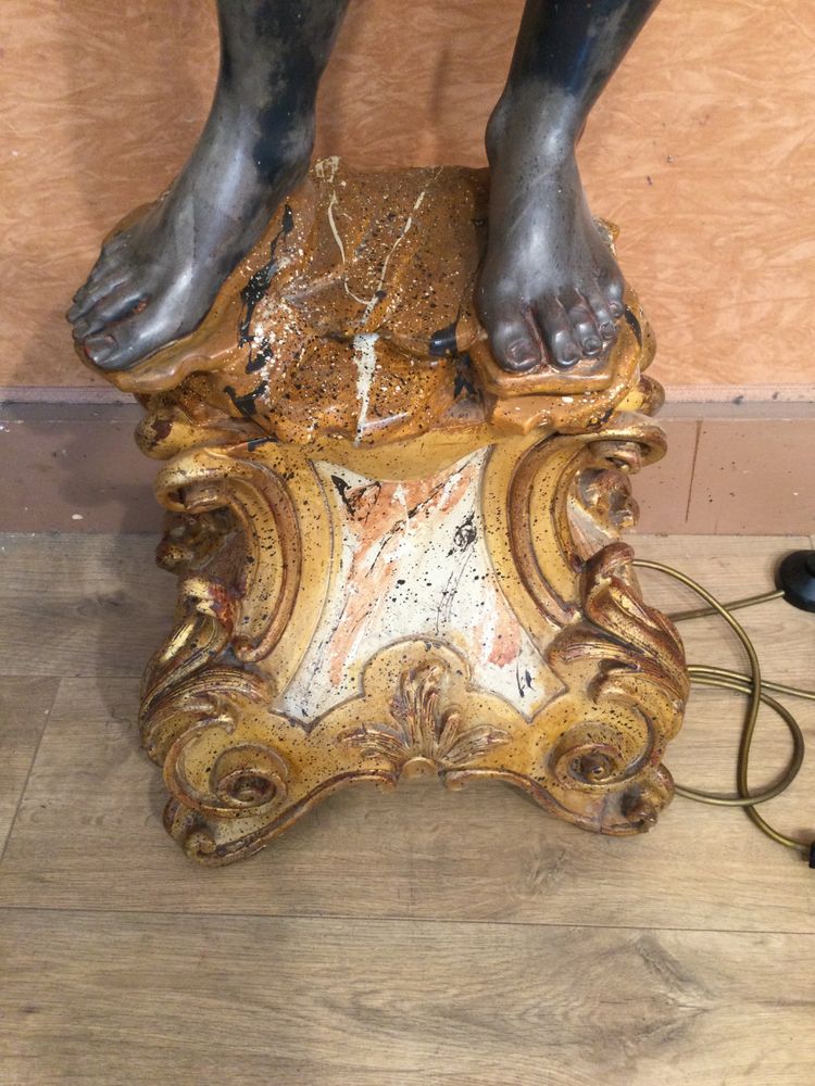 A large "Nubian" floor lamp in the Italian Baroque style, in painted and gilded wood.