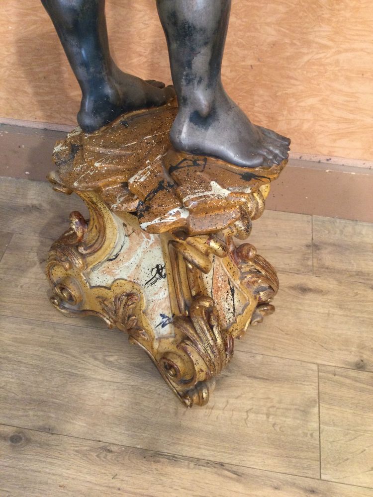 A large "Nubian" floor lamp in the Italian Baroque style, in painted and gilded wood.