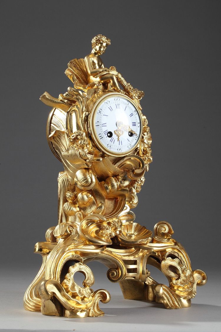Pendule de style Rocaille en bronze doré, ornée d'un Amour dans une coquille