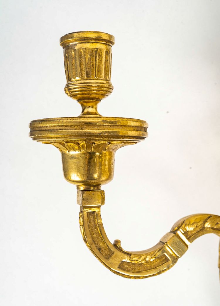 Coppia di appliques in bronzo cesellato e dorato in stile Luigi XVI con due bracci di luce 1820 ca.