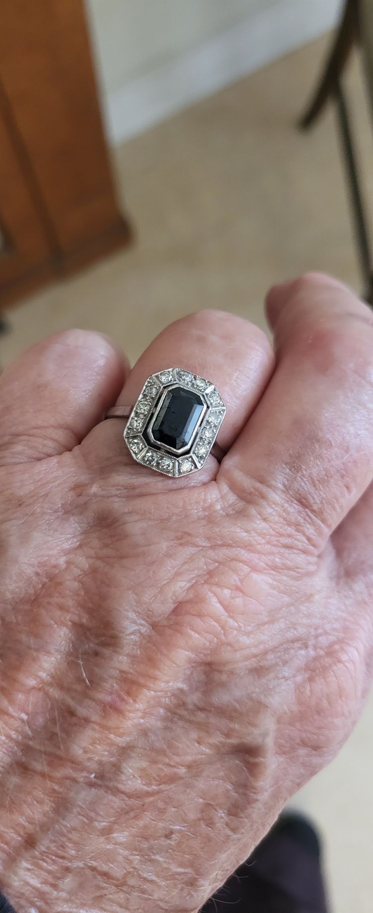 Platinum ring set with a blue sapphire and surrounded by Art Deco diamonds