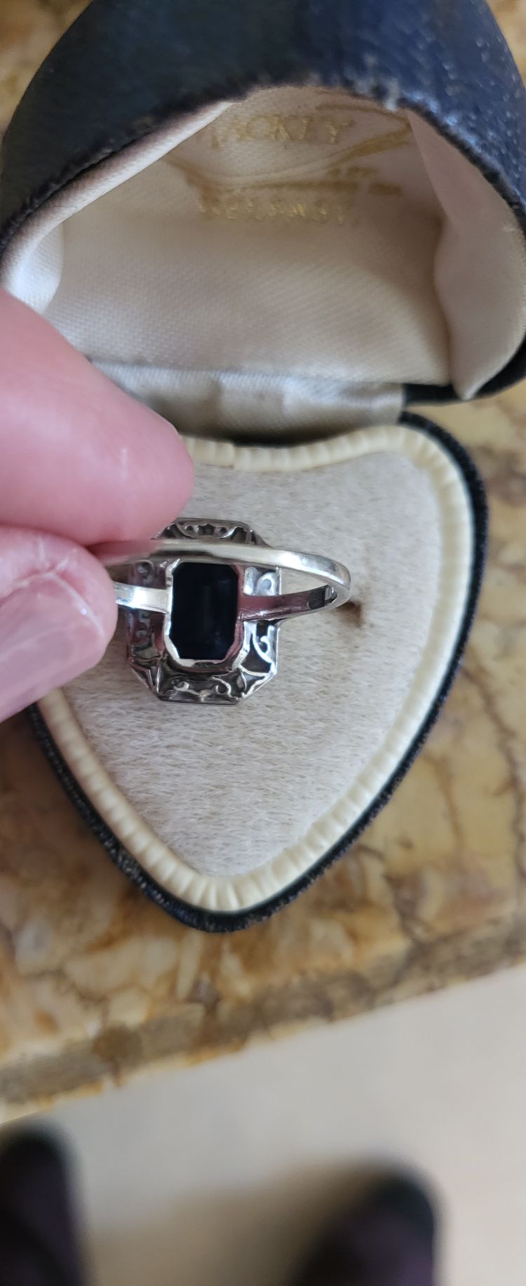 Platinum ring set with a blue sapphire and surrounded by Art Deco diamonds