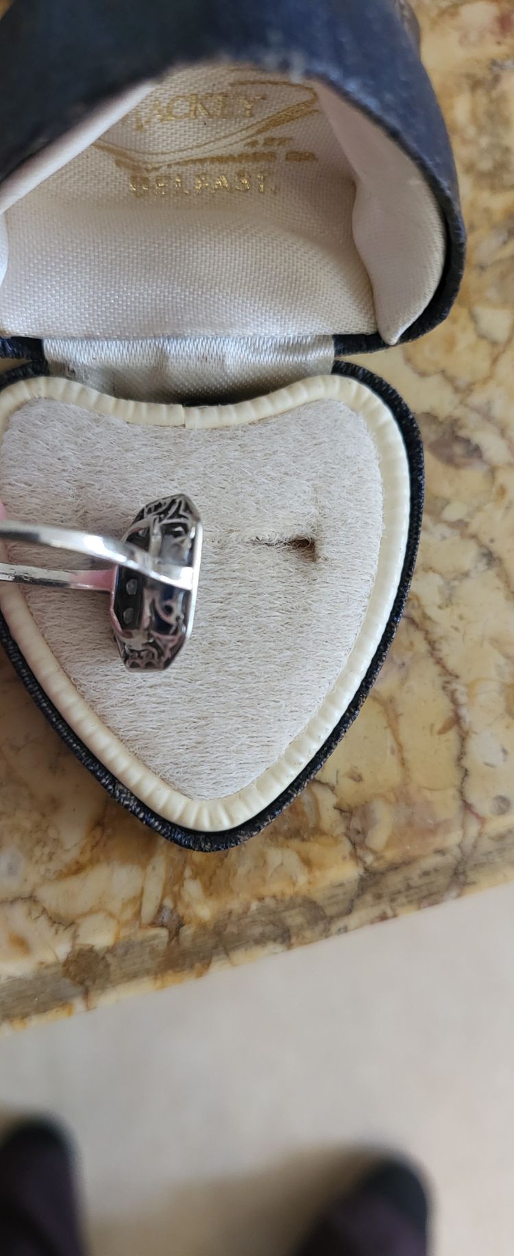 Platinum ring set with a blue sapphire and surrounded by Art Deco diamonds