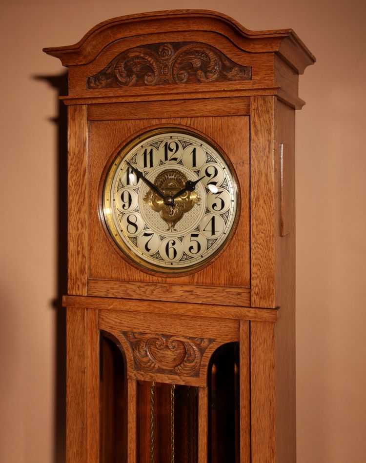 Impressive, magnificent Art Deco Dutch parquet clock in gilded oak.