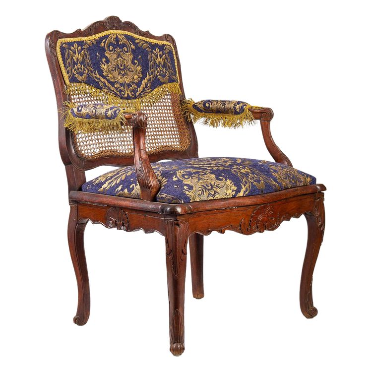 Fauteuil à fond de cannes en bois naturel mouluré et sculpté d’époque Régence vers 1720