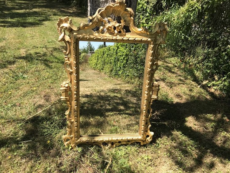 Antique Louis XV style gilded wood mirror from the 20th century