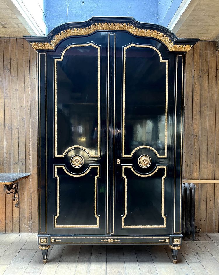 Large wardrobe in blackened and gilded wood