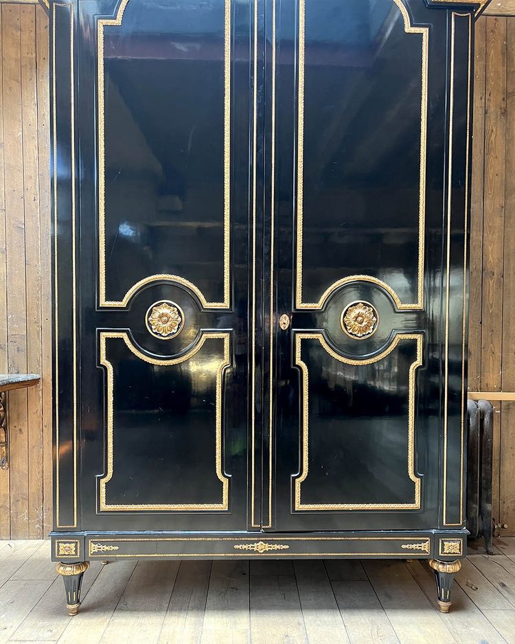 Large wardrobe in blackened and gilded wood