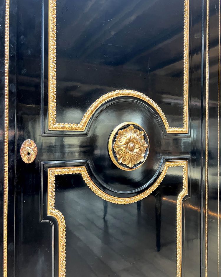 Large wardrobe in blackened and gilded wood