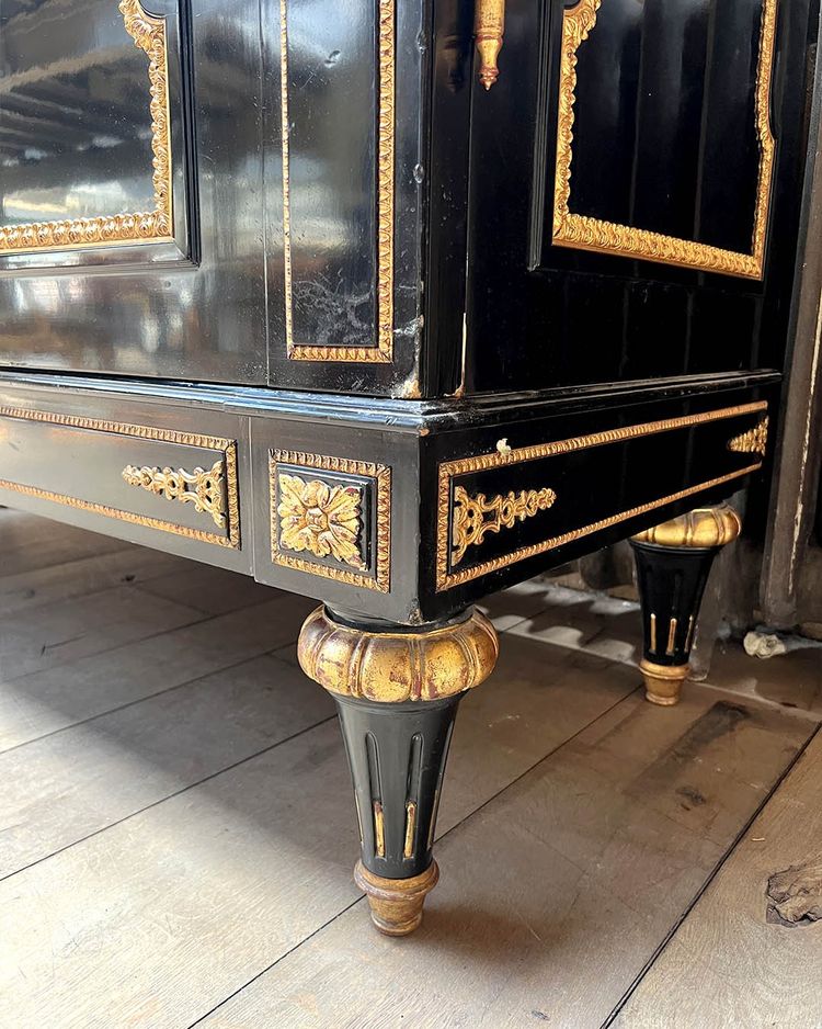 Large wardrobe in blackened and gilded wood