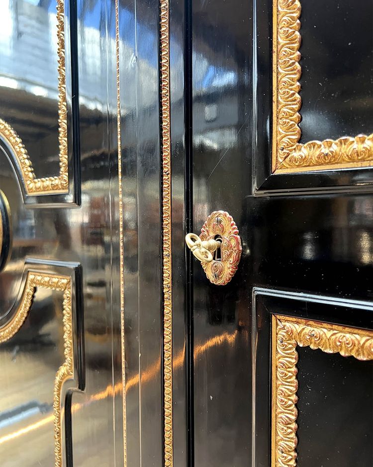 Large wardrobe in blackened and gilded wood