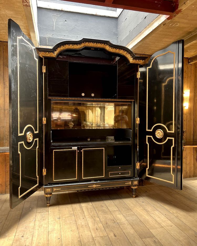 Large wardrobe in blackened and gilded wood