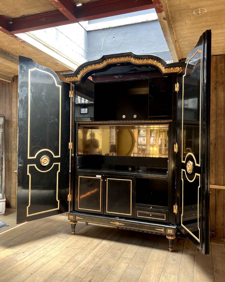 Large wardrobe in blackened and gilded wood