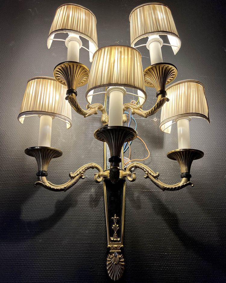 Pair of patinated bronze and gilt bronze wall lights with five arms