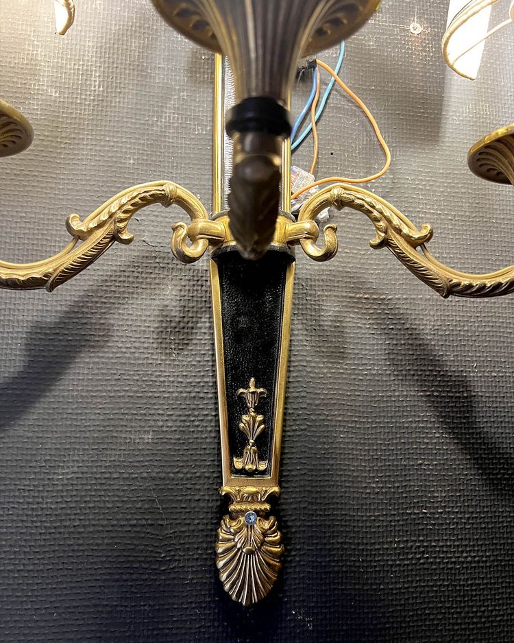 Pair of patinated bronze and gilt bronze wall lights with five arms