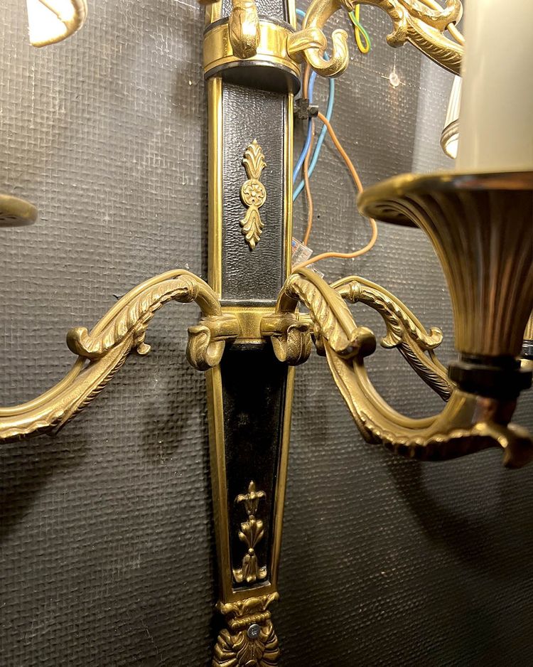 Pair of patinated bronze and gilt bronze wall lights with five arms