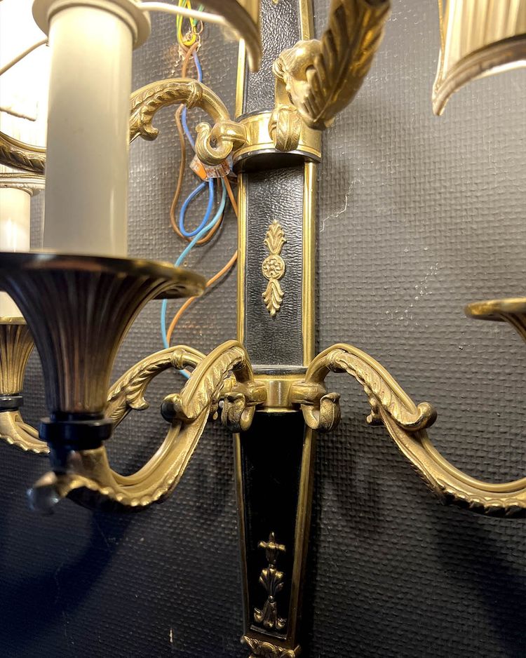 Pair of patinated bronze and gilt bronze wall lights with five arms