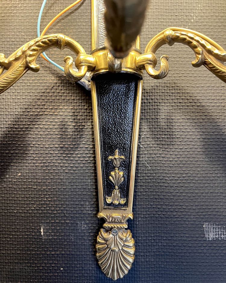 Pair of patinated bronze and gilt bronze wall lights with five arms