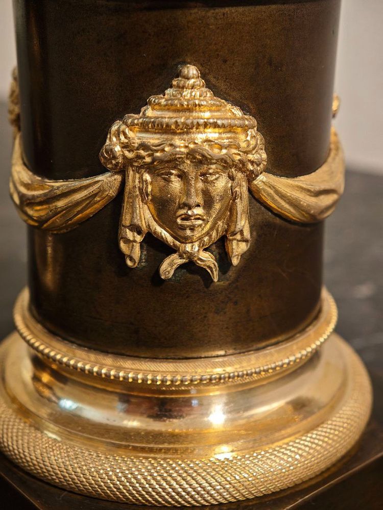 Pair of Candlesticks with Antique Figures and Poppies in patinated and gilded bronze, Directoire period.