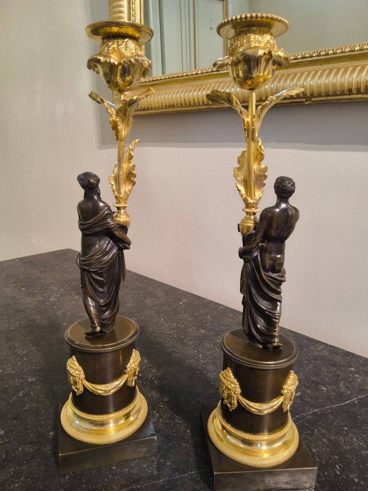 Pair of Candlesticks with Antique Figures and Poppies in patinated and gilded bronze, Directoire period.