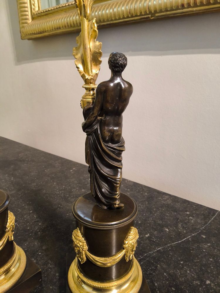 Pair of Candlesticks with Antique Figures and Poppies in patinated and gilded bronze, Directoire period.