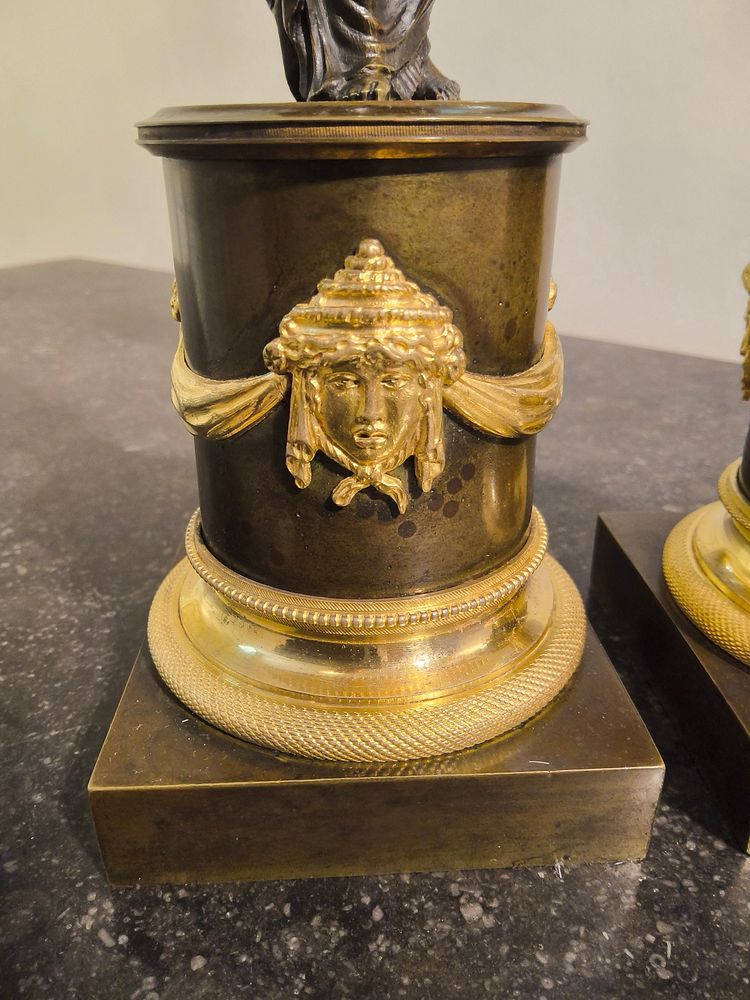 Pair of Candlesticks with Antique Figures and Poppies in patinated and gilded bronze, Directoire period.
