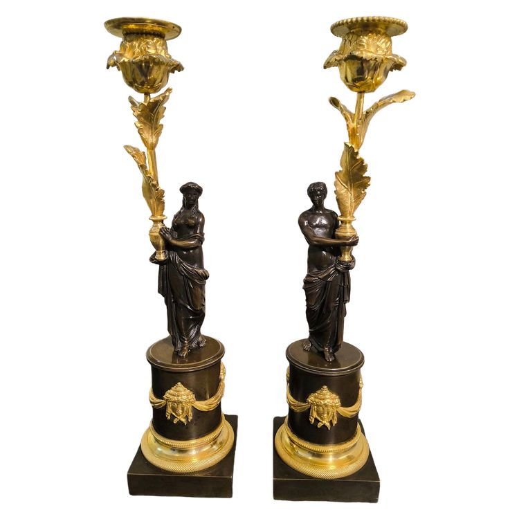 Pair of Candlesticks with Antique Figures and Poppies in patinated and gilded bronze, Directoire period.