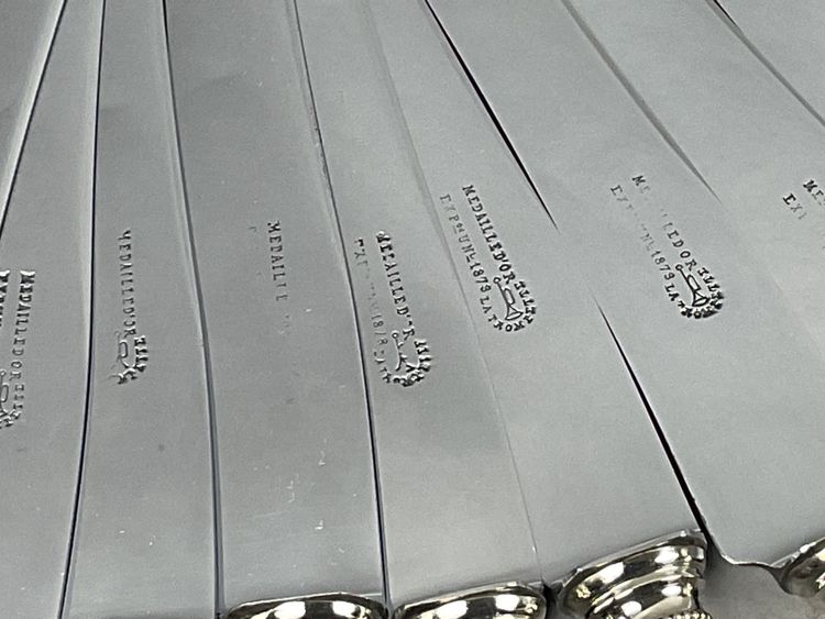 12 table knives with ebony handles and pearl decoration