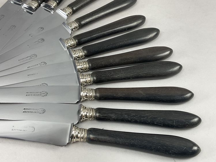 12 table knives with ebony handles and pearl decoration