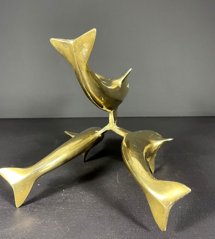 France, Ostrich egg mounted on a brass tripod base with a representation of dolphins, 1970.