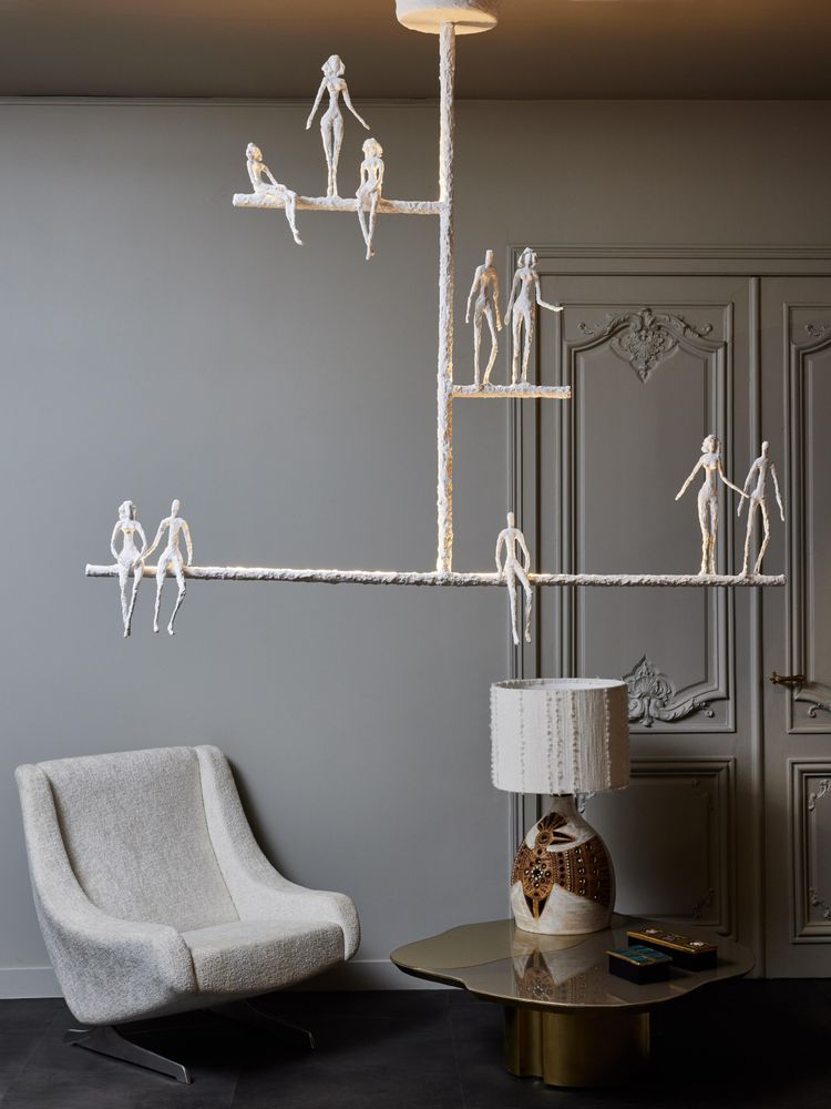 Linear chandelier with characters from Glustin Luminaires