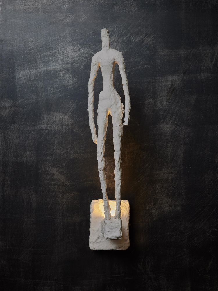 Wall lights with plaster characters from Glustin Luminaires