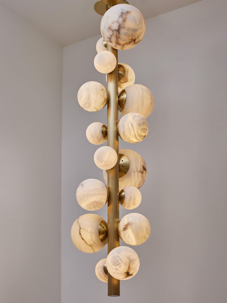 Vertical brass chandelier with alabaster globes