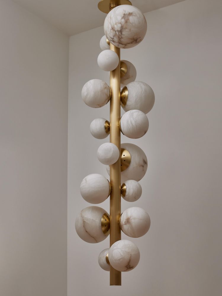 Vertical brass chandelier with alabaster globes