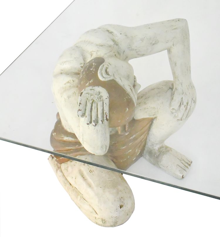 Coffee table with two figures holding a glass tray