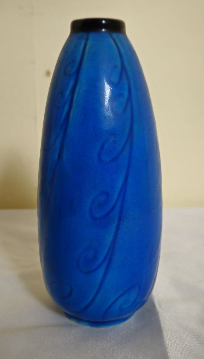 Eine sehr hübsche Vase aus intensiv blau glasierter Keramik, verziert mit dezenten Wellenmustern im Material.