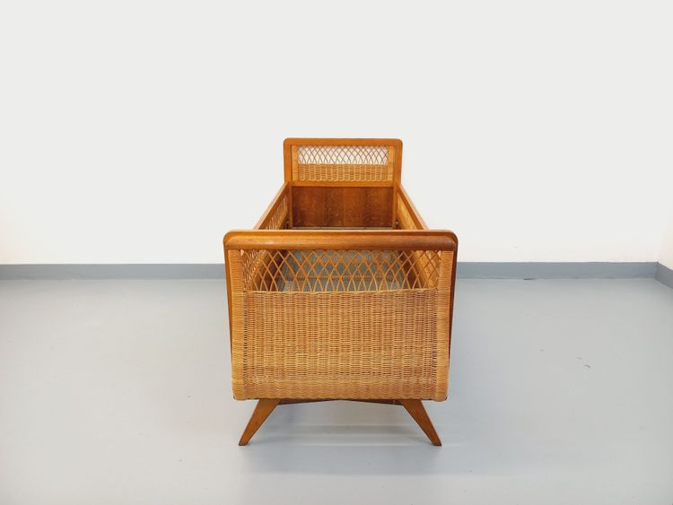 Vintage baby cot made of oak and rattan from the 1960s