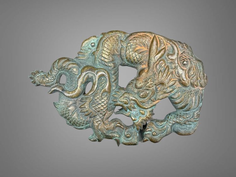 Embossed and finely engraved copper maedate featuring a dragon in clouds - Edo period. -