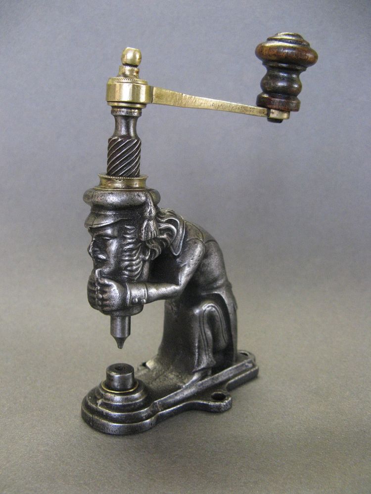 Anthropomorphic eyelet press, 19th century, circa 1800.