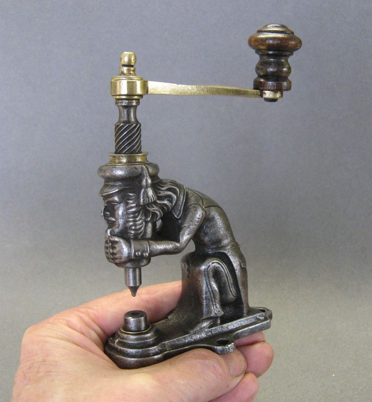 Anthropomorphic eyelet press, 19th century, circa 1800.