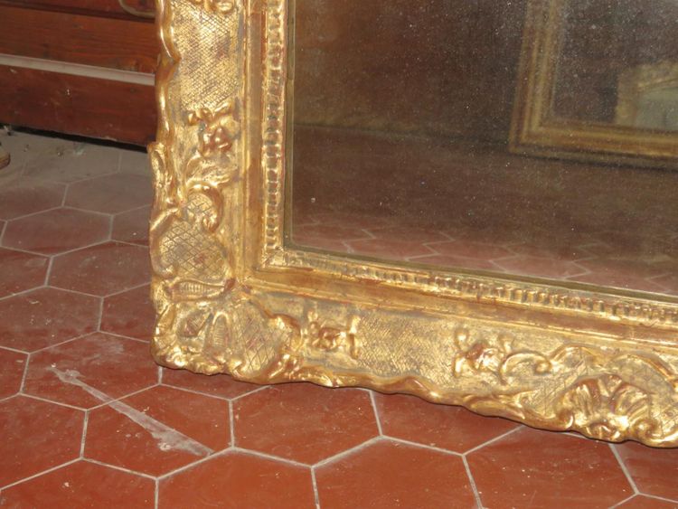 17th century Louis XIV style mirror in gilded wood.