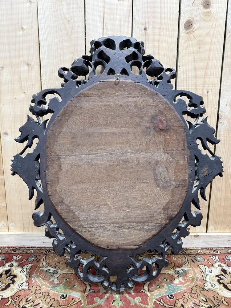 Miroir ovale en bois sculpté à tête de dragons