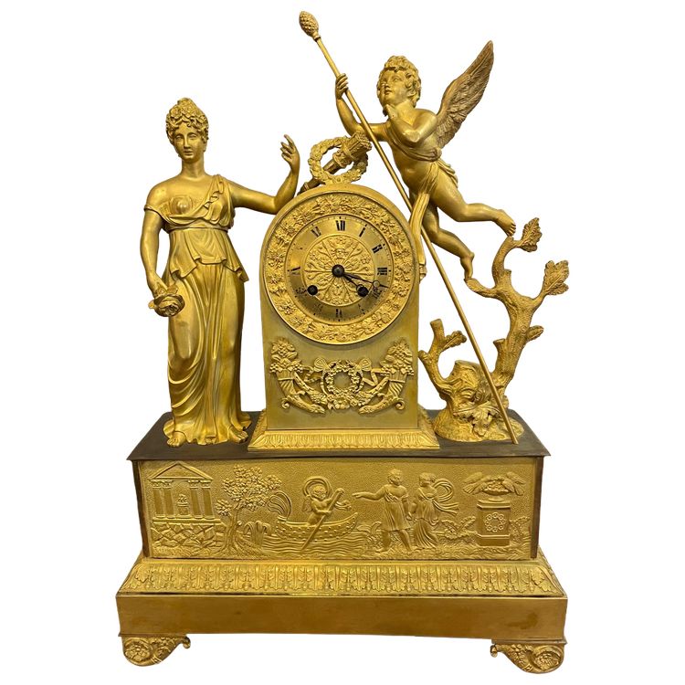 Pendule en bronze ciselé et doré à décor d’une femme à l’Antique et d’un Amour .