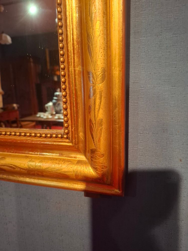 Louis-Philippe period mirror gilded with gold leaf.
